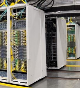 Image shows rows of racks of servers in an AI datacenter