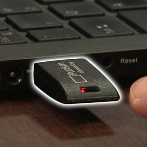 Image shows the Librem Key plugged into a computer with a red LED lit
