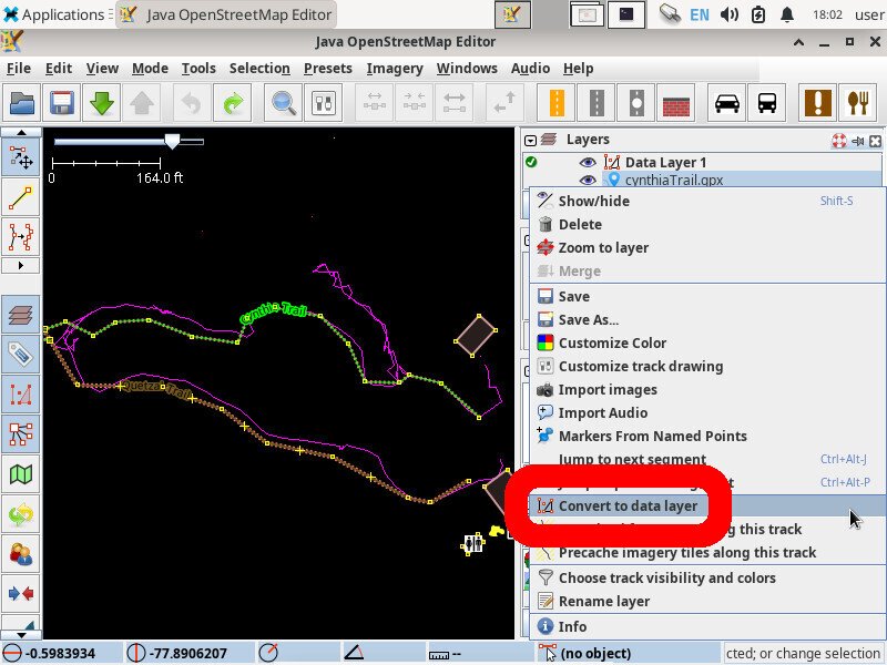 Screenshot of the JOSM application showing a big looping path. There is also some square buildings, a WC icon, and some additional paths.